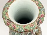 a vase with a floral design on it on a white surface