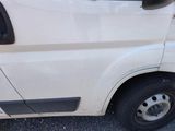 a white van that is parked on the side of the road