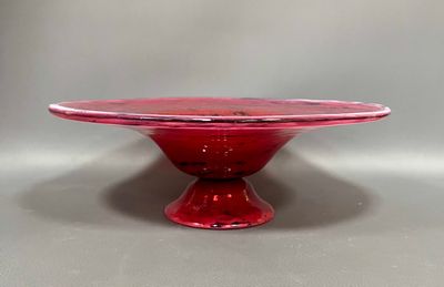 an image of a red glass cake plate on a table