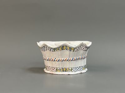 a white bowl with a pattern on it on a gray surface