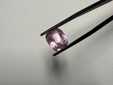 a close up of a pair of tweet tongs holding a pink diamond