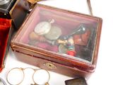 a small box with a watch and other items in it