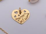 a gold heart shaped pendant with a message on it