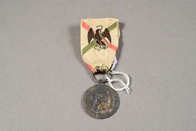 a small medal with an eagle on it on a table