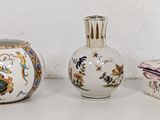 three vases and a box sitting on a table