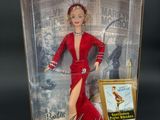 doll in a box with a picture of a woman in a red dress