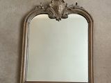 a mirror on the wall above a sink in a bathroom