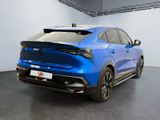 the rear end of a blue car parked in a garage