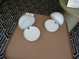 a table with two white cups on it and a brown table with a black and white pattern