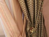 a close up of a curtain hanging on a curtain rod