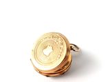 a close up of a gold coin on a white surface