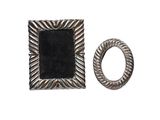 a close up of a ring and a picture frame on a white background