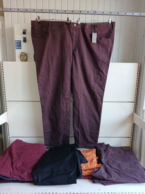 purple pants hanging on a clothes rack in front of a window
