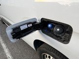 a white van with an electric charger attached to it ' s side