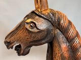 statue of a horse with a golden mane on a white background