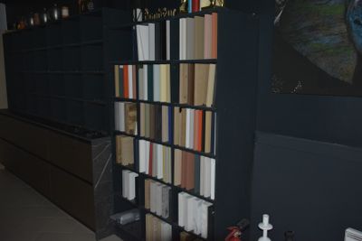 a book shelf with many books on it in a room