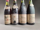 four bottles of wine are lined up on a table