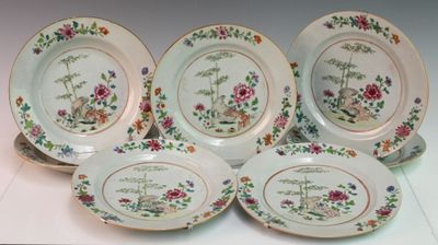 four plates with floral designs on them sitting on a table