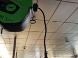 a picture of a green and black camera mounted to a ceiling