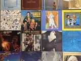 many different album covers on the wall of this room