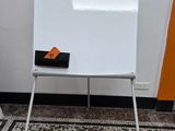 a white board sitting on a stand in a room