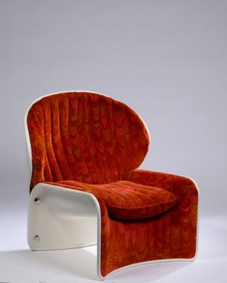an orange and white chair sitting on top of a white floor