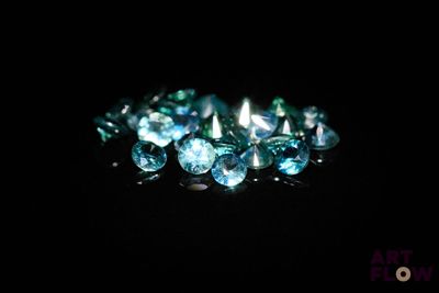 some very pretty blue diamonds on a black surface