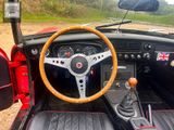 a steering wheel and dashboard of a car in a field