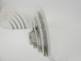 several white plates are stacked on top of each other on a white surface