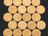 un tas de pièces d'or sur lesquelles sont représentés des visages