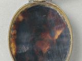 a small tortoise shell locke with a gold clasp