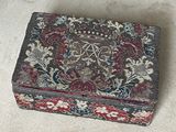 a small box with a floral design on it