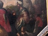 a painting on the wall of a building with a painting of a man on a horse