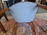 two chairs that are sitting on a rug in a room
