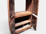 an old wooden cabinet with a mirror on top of it