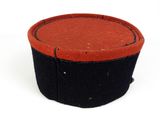 a small red and black box on a white surface