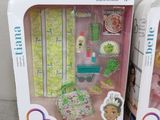 packaging of two dolls in boxes on a couch with a white background