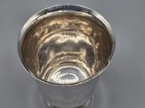 a silver cup that is sitting on a table
