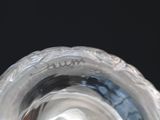 a close up view of a glass vase with a black background