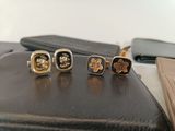 three pairs of cuff rings sitting on top of a black purse
