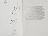 an open book with a drawing of a person hanging from a tree