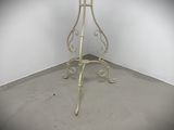 a white table with a glass top in a corner