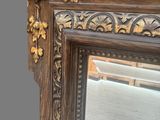 a mirror with a bird on the top and a bird on the bottom
