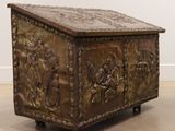 a wooden box with carvings on it sitting on the floor