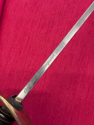 a close up of a sword on a red cloth