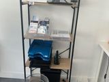 a shelf that has a laptop and a bucket on it