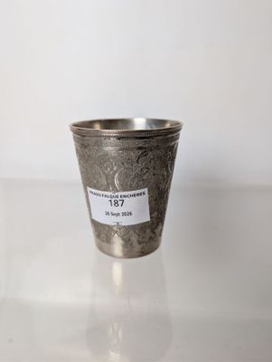 a silver cup with a label on it sitting on a table