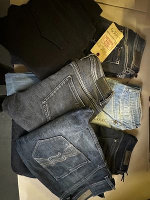 several pairs of jeans are stacked on top of each other in a drawer