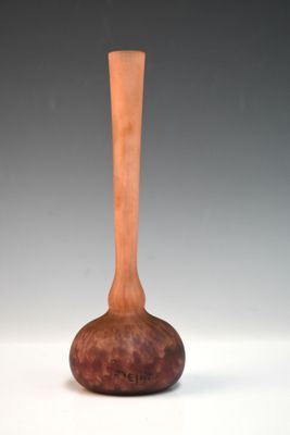 un vase en bois posé sur une table près d'un mur blanc