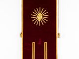 an image of a red and gold flag hanging on a wall